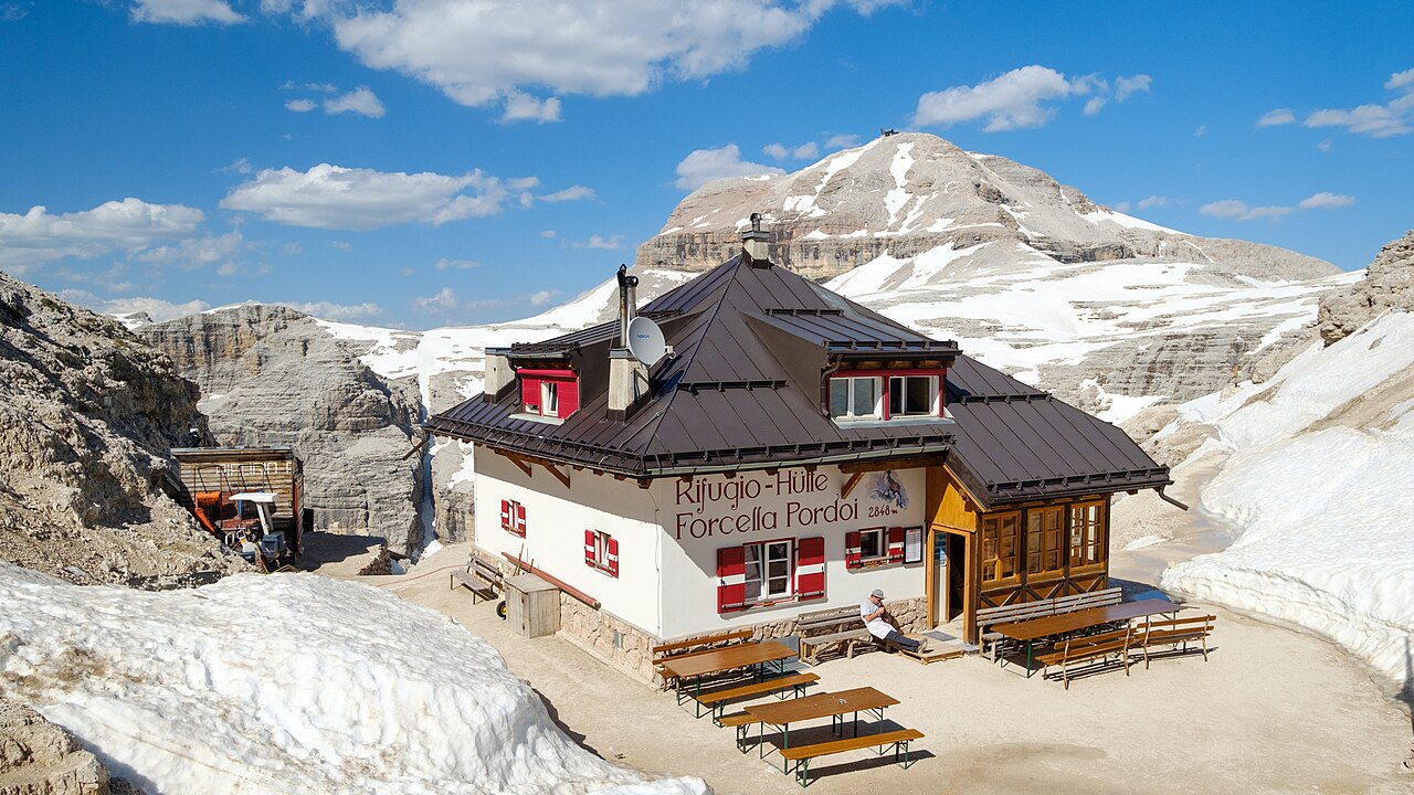 Il Rifugio Forcella Pordoi a 2.848 metri, con neve residua e il Piz Boè sullo sfondo in una fotografia del giugno 2019