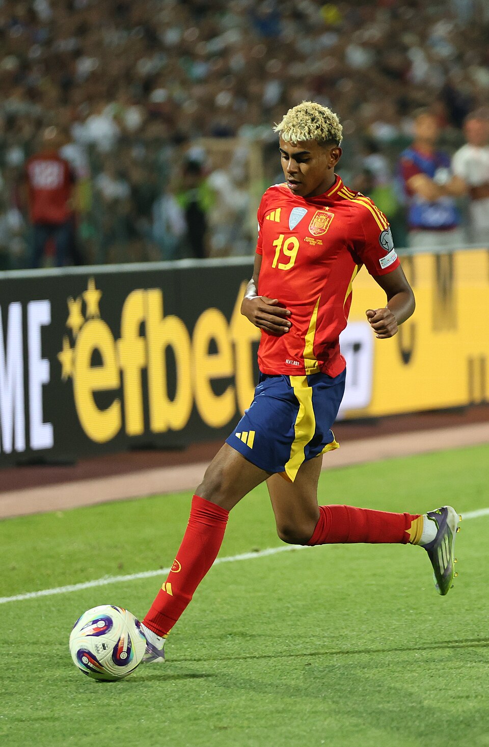 Lamine Yamal con la maglia rossa numero 19 della Spagna mentre controlla il pallone contro la Bulgaria nel settembre 2025