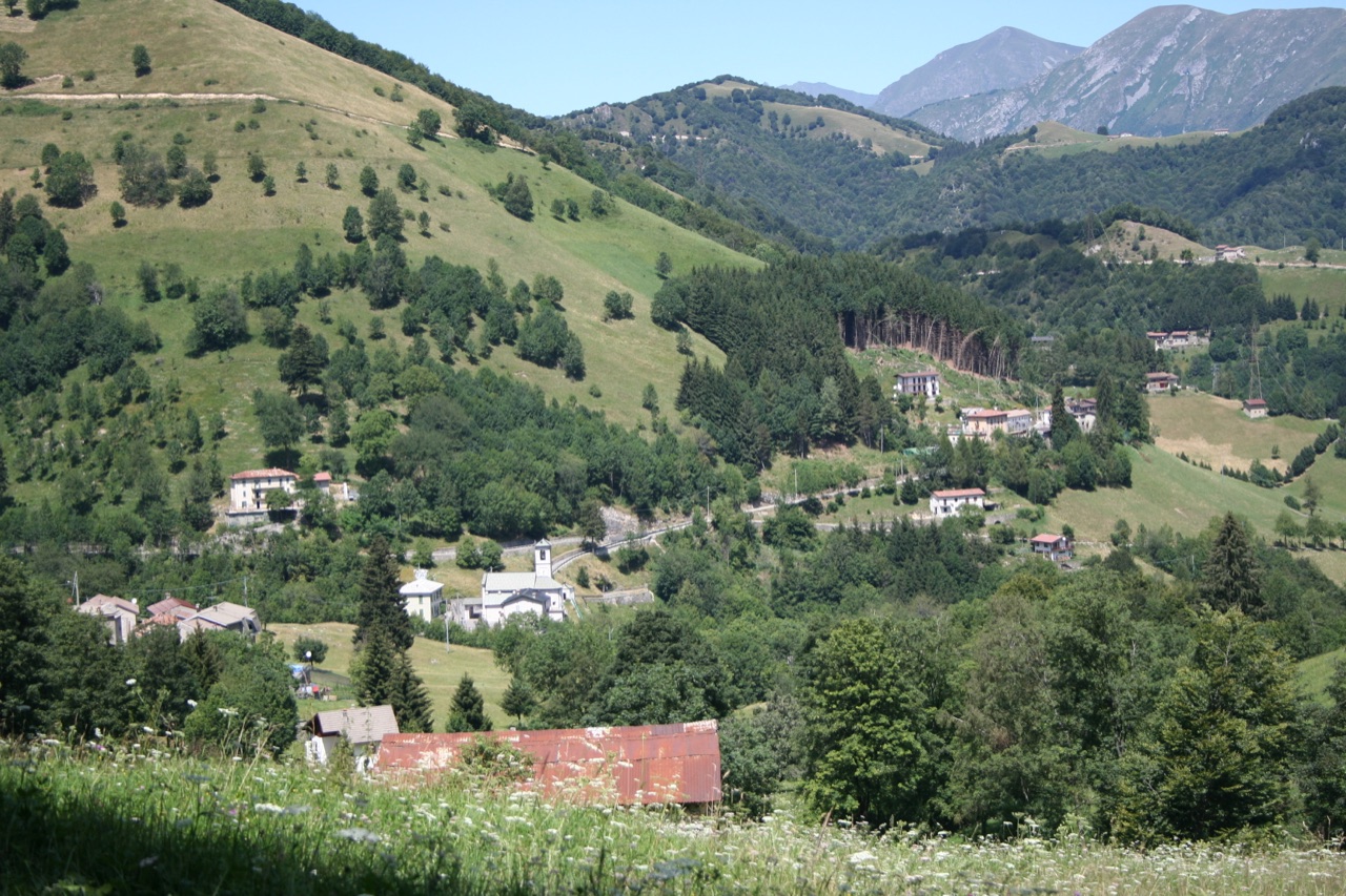 Morterone con la chiesa e le case sparse nella conca montana ai piedi del Resegone